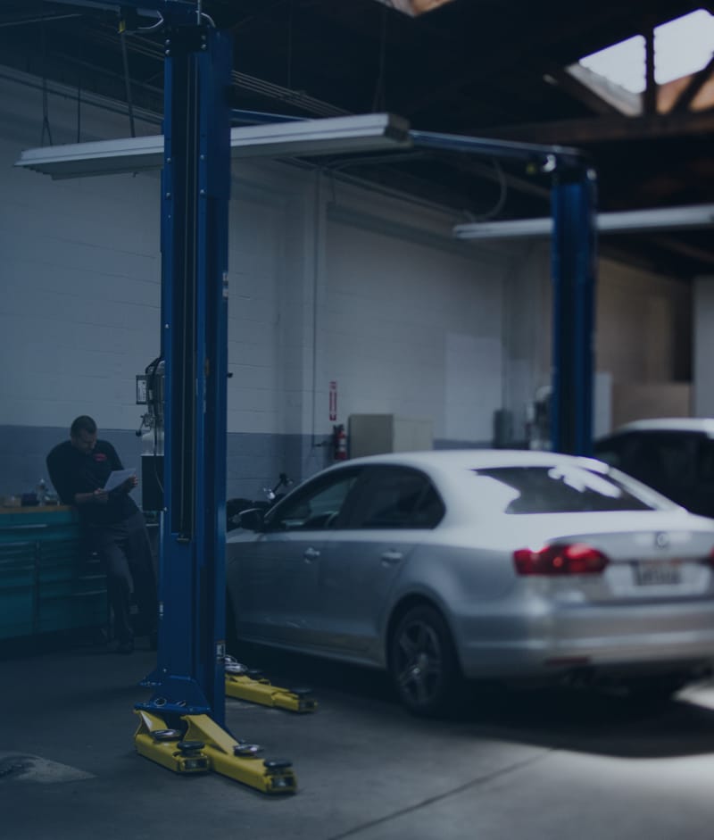 Inside of a collision shop showing a car